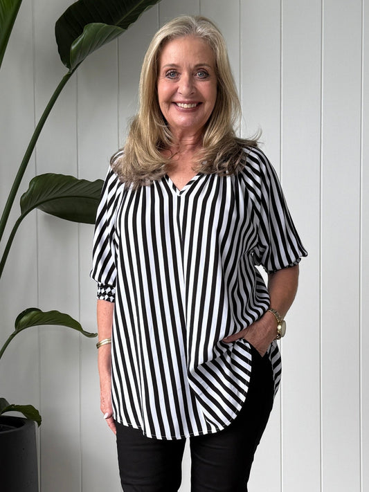 Image of a model wearing Outerwear. Product name - Harlequin Stripe Print Tunic Black/White in Black/White colour by brand - Threadz