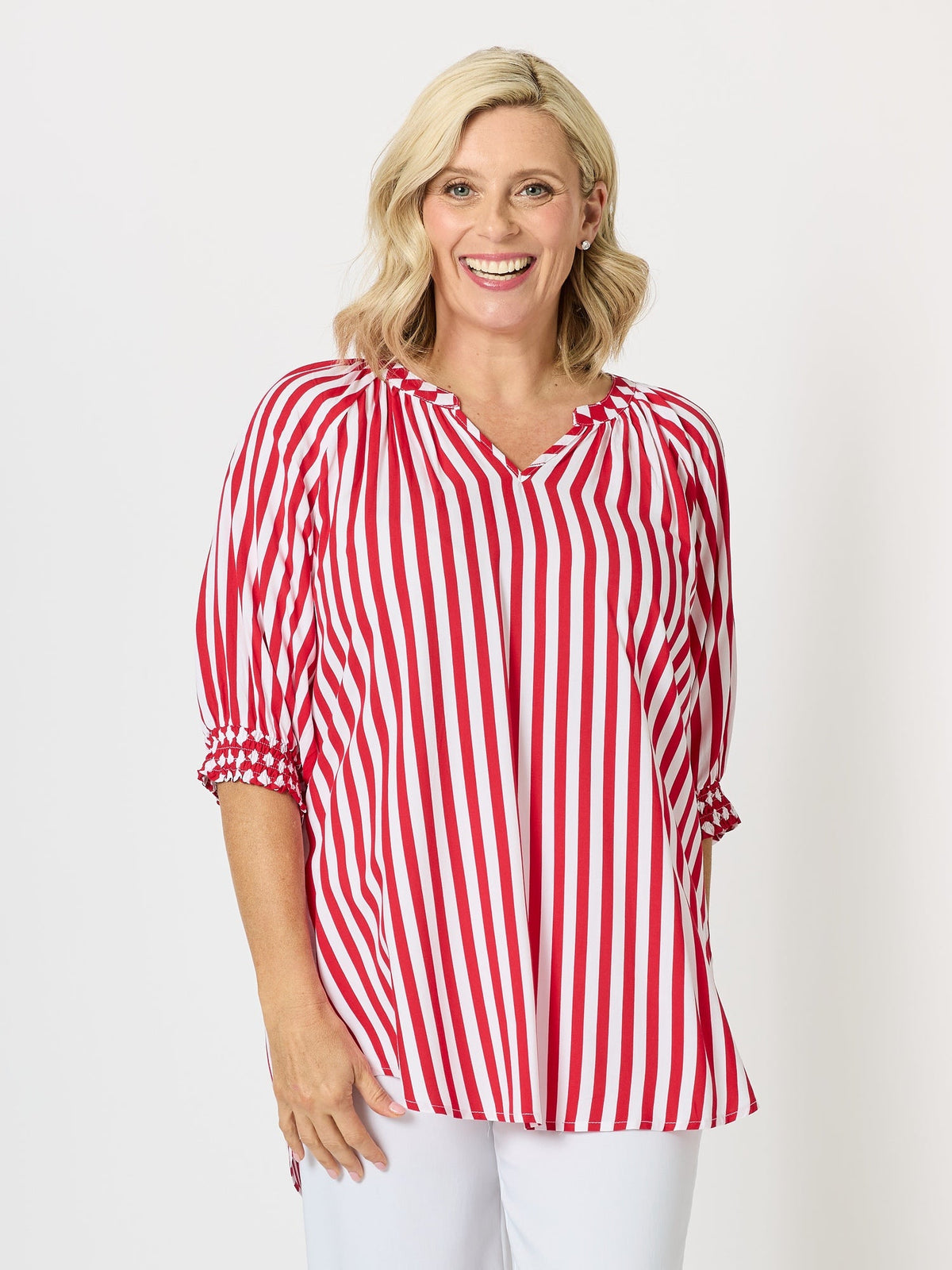 Image of a model wearing Outerwear. Product name - Harlequin Stripe Print Top Red White in Red White colour by brand - Threadz