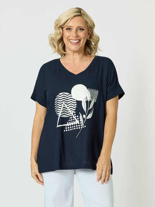 Image of a model wearing Tops. Product name - Orbit Print Top Navy in Navy colour by brand - Clarity