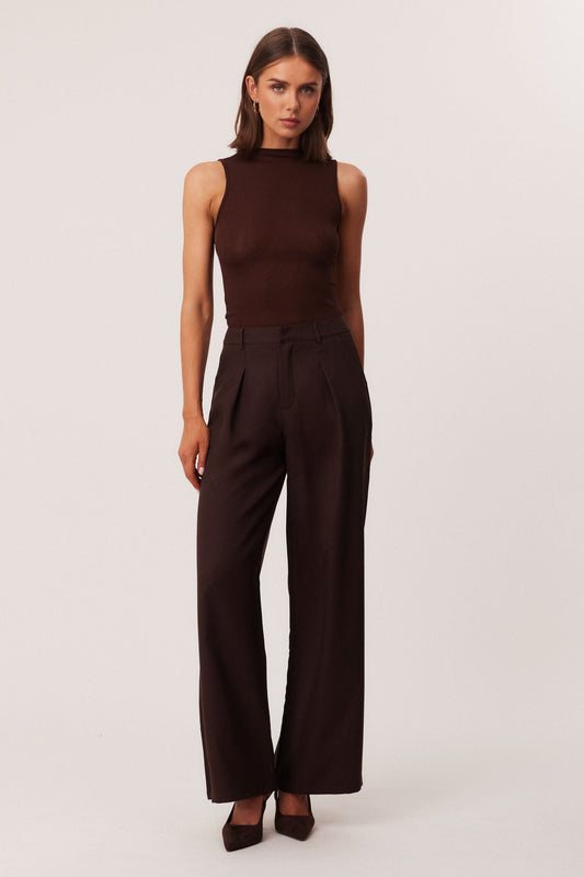 Image of a model wearing Pants. Productname: SNDYS WOODS PANTS in Chocolate colour by brand - SNDYS