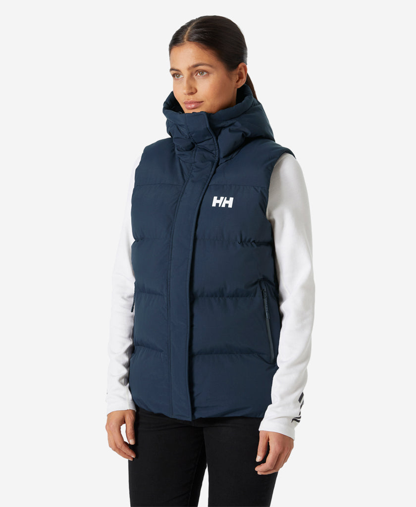 Image of a model wearing Outerwear. Product name - W ADORE PUFFY VEST, Navy in Navy colour by brand - Helly Hansen