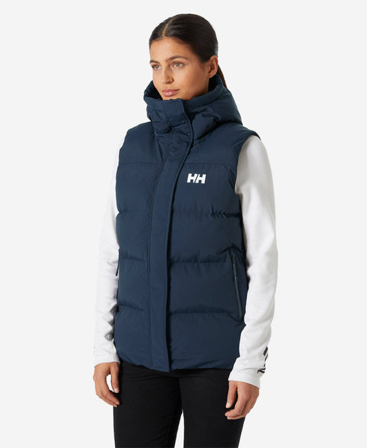Image of a model wearing Outerwear. Product name - W ADORE PUFFY VEST, Navy in Navy colour by brand - Helly Hansen