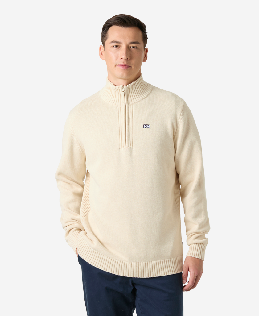 Image of a model wearing Outerwear. Product name - SMOEGEN 1/2 ZIP SWEATER, Cream in Cream colour by brand - Helly Hansen