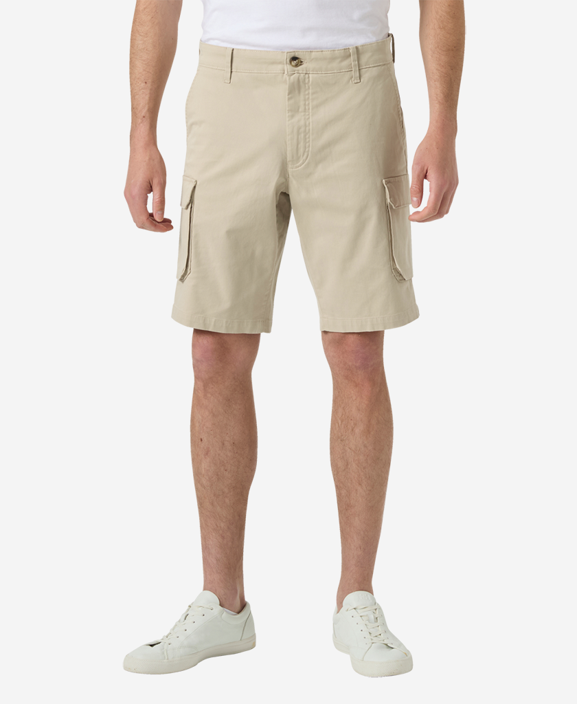Image of a model wearing Shorts. Product name - BRYGGEN CARGO SHORTS, Khaki in Khaki colour by brand - Helly Hansen