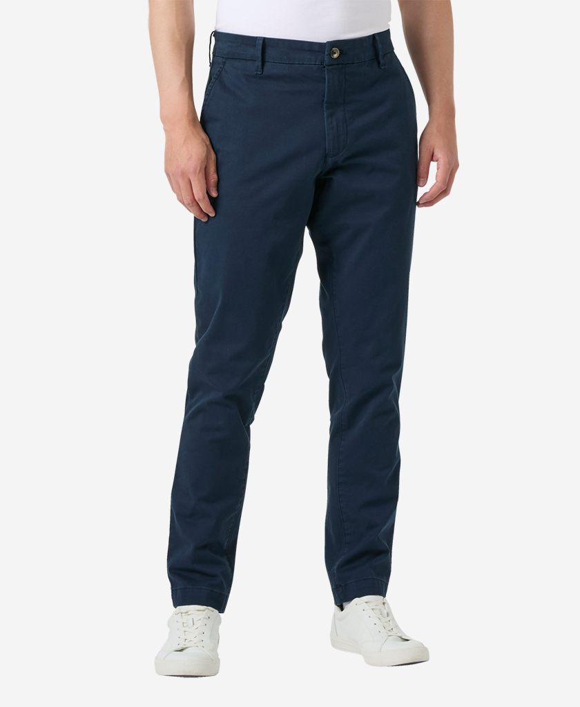 Image of a model wearing Pants. Product name - BRYGGEN CHINO PANT, Navy in Navy colour by brand - Helly Hansen