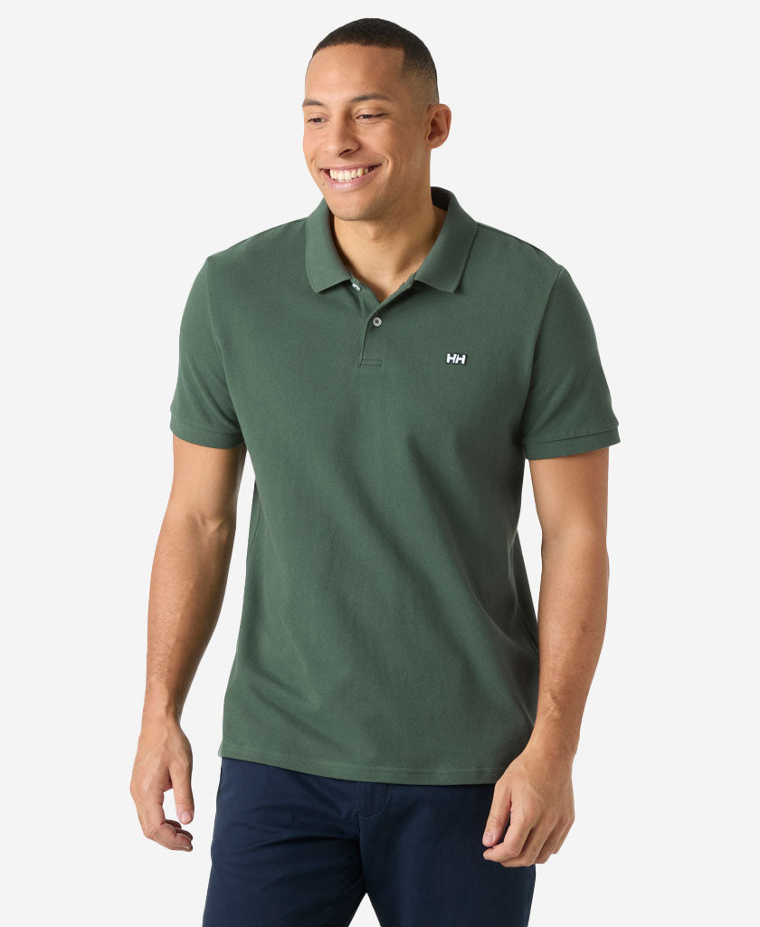 Image of a model wearing Tops. Product name - HUDSON POLO, Jungle Green in Jungle Green colour by brand - Helly Hansen