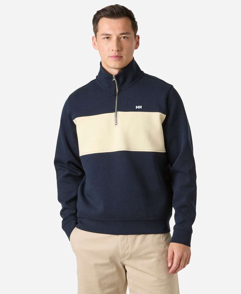 Image of a model wearing Outerwear. Product name - KOSTER SWEAT 1/2 ZIP, 598 Navy in Navy colour by brand - Helly Hansen