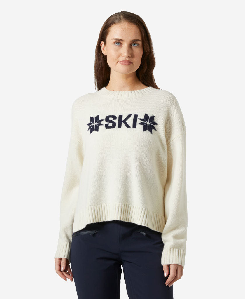 Image of a model wearing Outerwear. Product name - W BLISS SKI KNIT SWEATER, Cream in Cream colour by brand - Helly Hansen