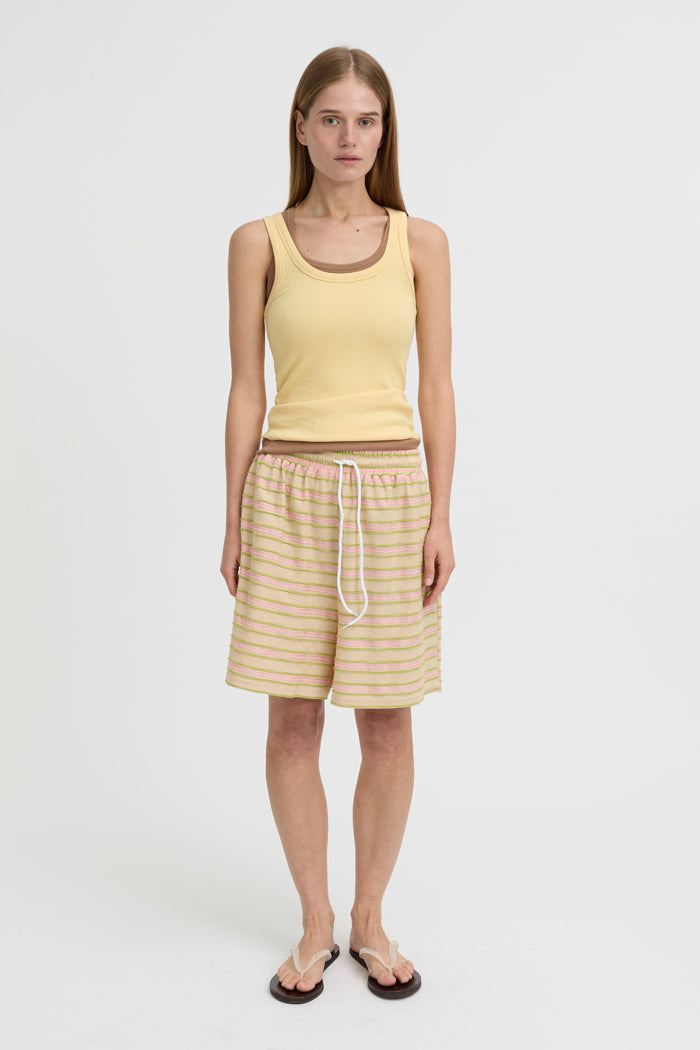 Image of a model wearing Tops. Product name - Antonia Tank Butter in Butter colour by brand - Blanca Studio