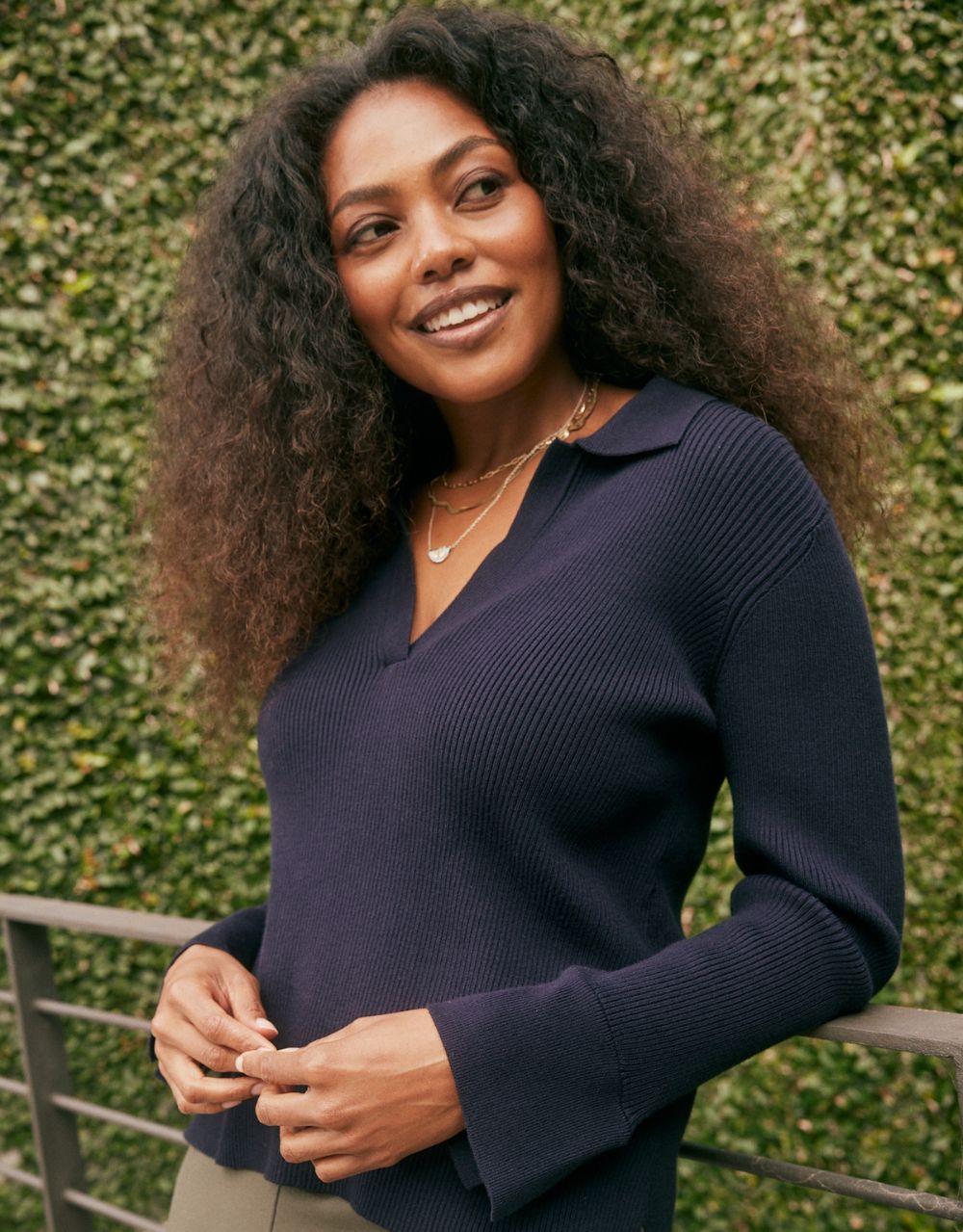 Image of a model wearing Tops. Product name - The Refined Rib Long Sleeve Top Navy in Navy colour by brand - White & Co.