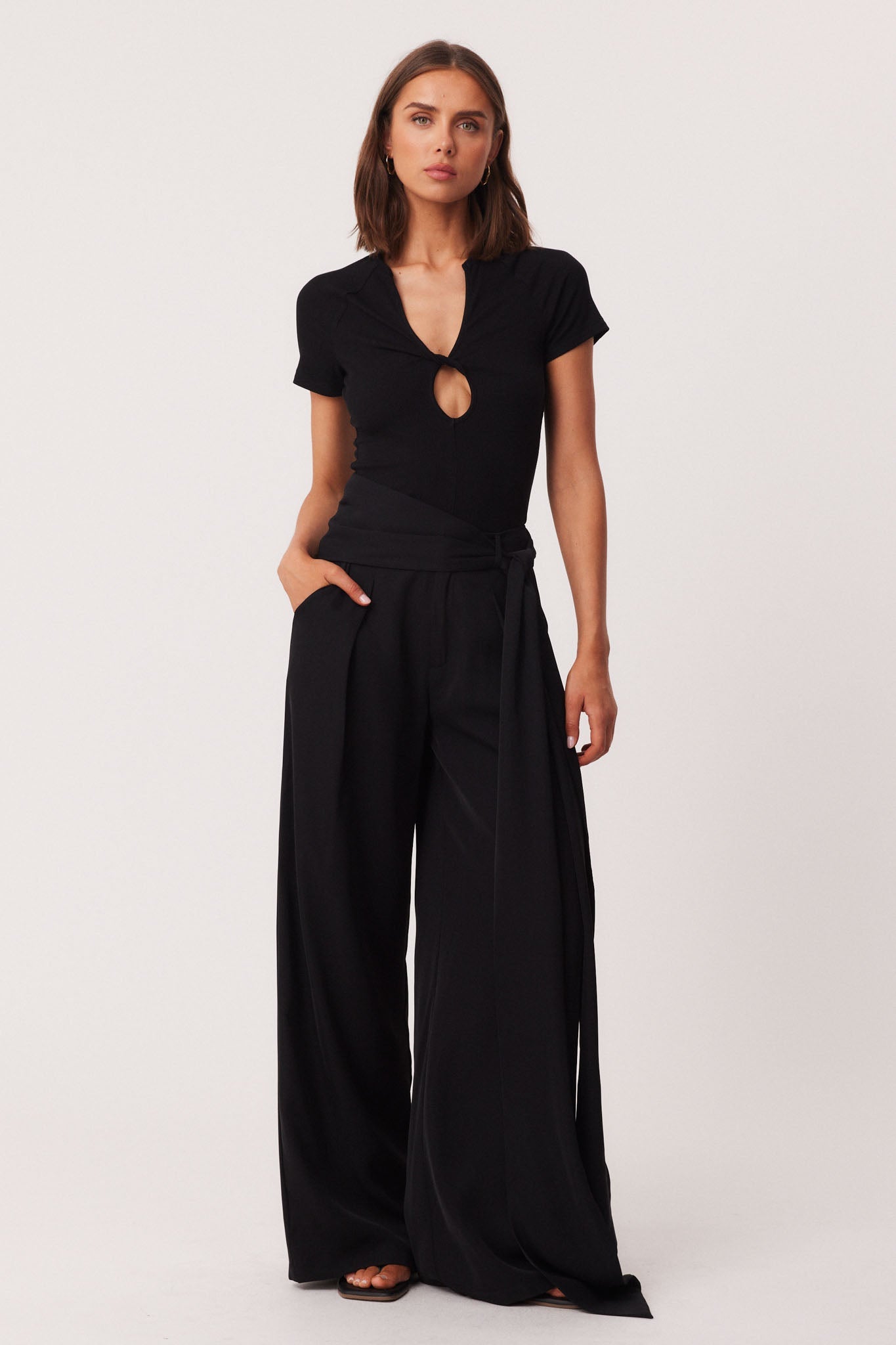 Image of a model wearing Pants. Productname: SNDYS REID PANTS in Black colour by brand - SNDYS