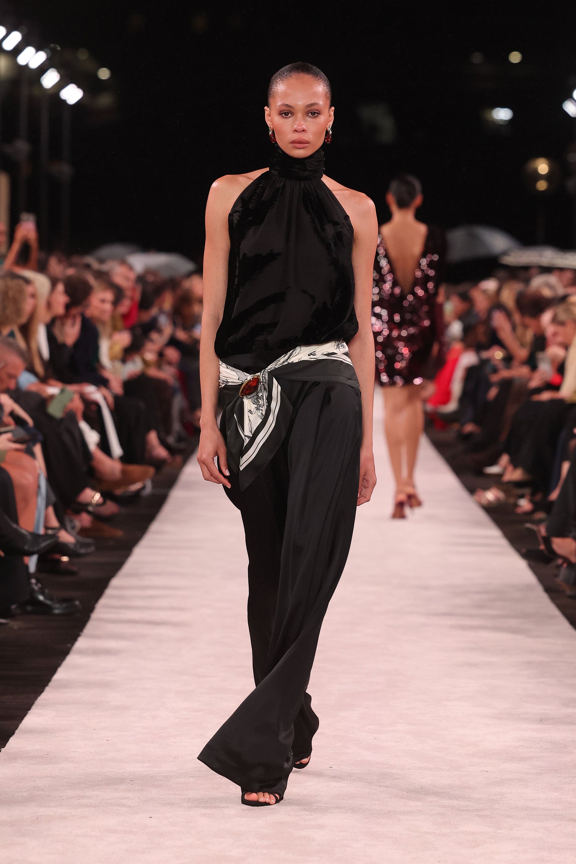 Image of a model wearing Pants. Product name - Black Satin Acetate Deep Pleat Pant in Black colour by brand - Carla Zampatti