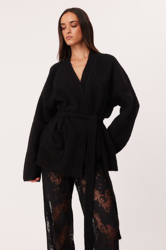 Image of a model wearing Outerwear. Productname: SNDYS DALIA KNIT CARDIGAN in Black colour by brand - SNDYS
