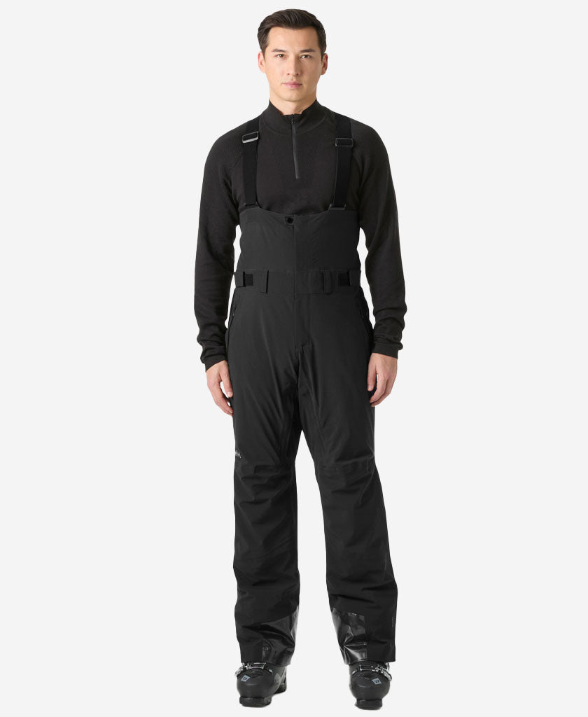 Image of a model wearing Pants. Product name - ALPHA BIB PANT, Black in Black colour by brand - Helly Hansen