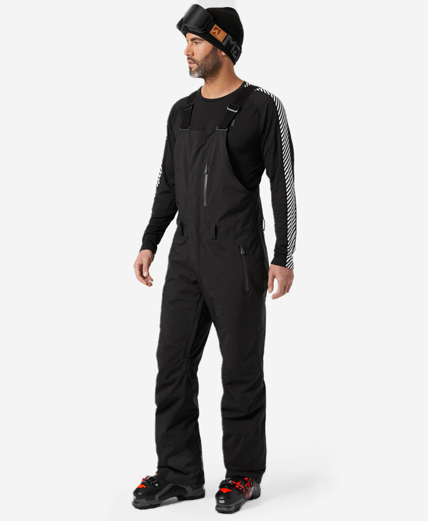 Image of a model wearing Pants. Product name - LEGENDARY INSULATED BIB PANT, Black in Black colour by brand - Helly Hansen