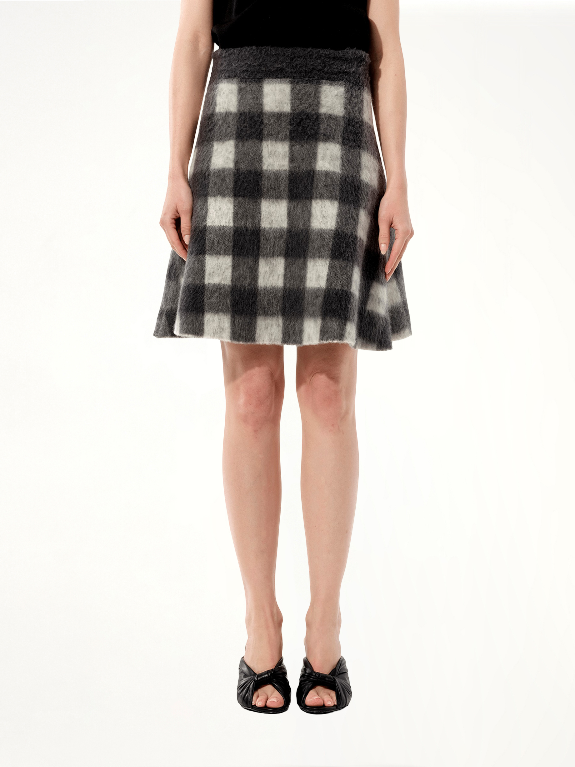 Image of a model wearing Skirts. Product name - Midi Skirt in Black colour by brand - BALENCIAGA