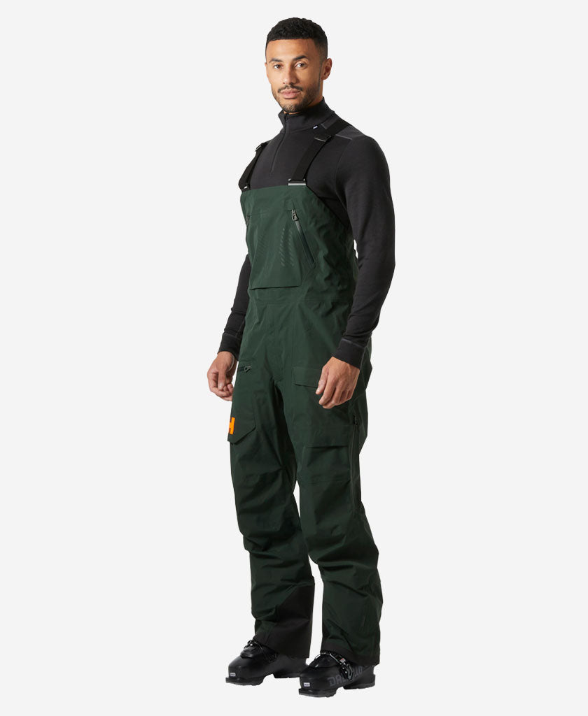 Image of a model wearing Pants. Product name - RIDGE INFINITY SHELL BIB, Dark Jungle in Dark Jungle colour by brand - Helly Hansen