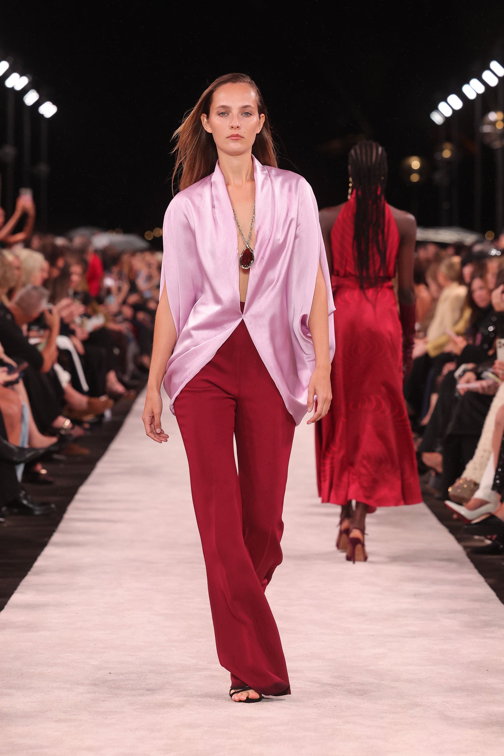 Image of a model wearing Pants. Product name - Cabernet Crepe Bootleg Pant in Red colour by brand - Carla Zampatti