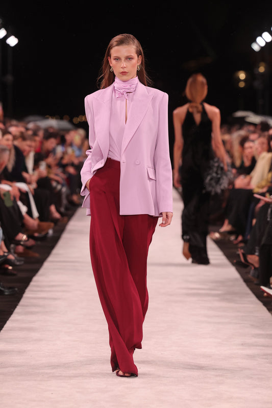 Image of a model wearing Pants. Product name - Cabernet Crepe Deep Pleat Pant in Red colour by brand - Carla Zampatti