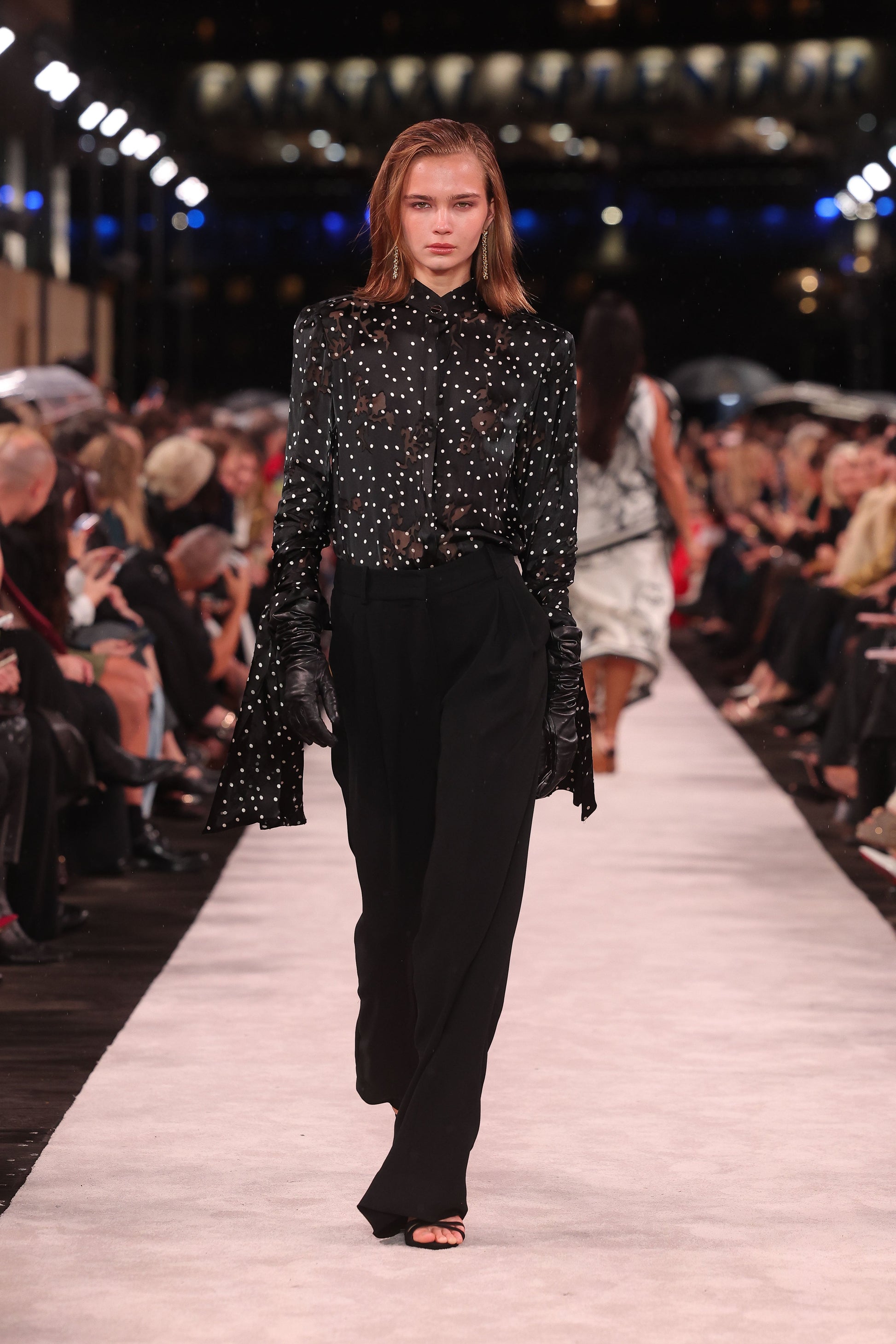 Image of a model wearing Tops. Product name - Pinspot Silk Burnout Front Neck Drape Blouse in Black colour by brand - Carla Zampatti