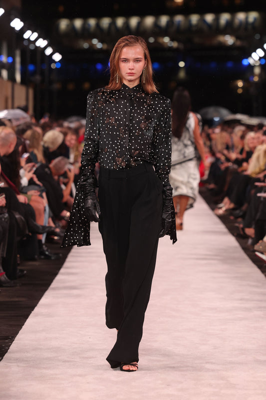 Image of a model wearing Pants. Product name - Black Crepe Wide Leg Pleated Pant in Black colour by brand - Carla Zampatti