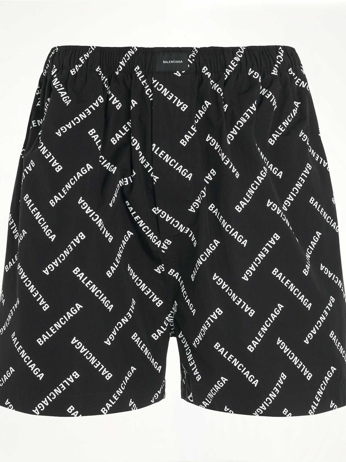Image of a model wearing Shorts. Productname: BALENCIAGA All-Over Logo Pyjama Shorts in BLACK colour by brand - BALENCIAGA