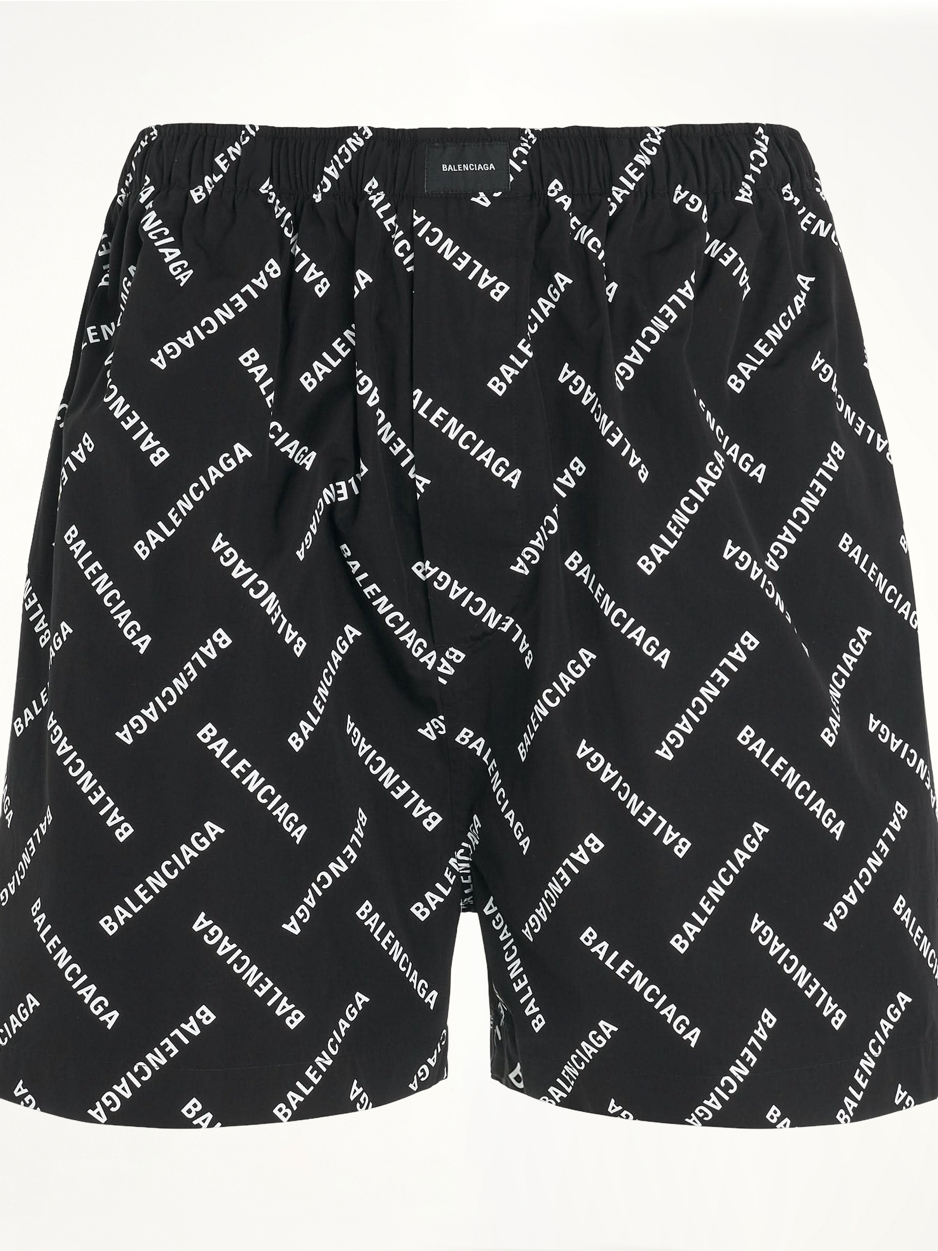 Image of a model wearing Shorts. Productname: BALENCIAGA All-Over Logo Pyjama Shorts in BLACK colour by brand - BALENCIAGA