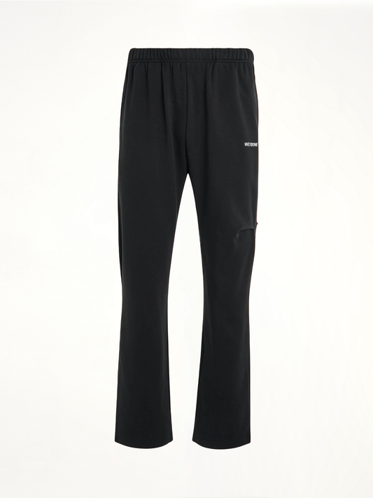 Image of a model wearing Pants. Productname: WE11DONE Back Logo Wide Jogger Pants in Black colour by brand - WE11DONE