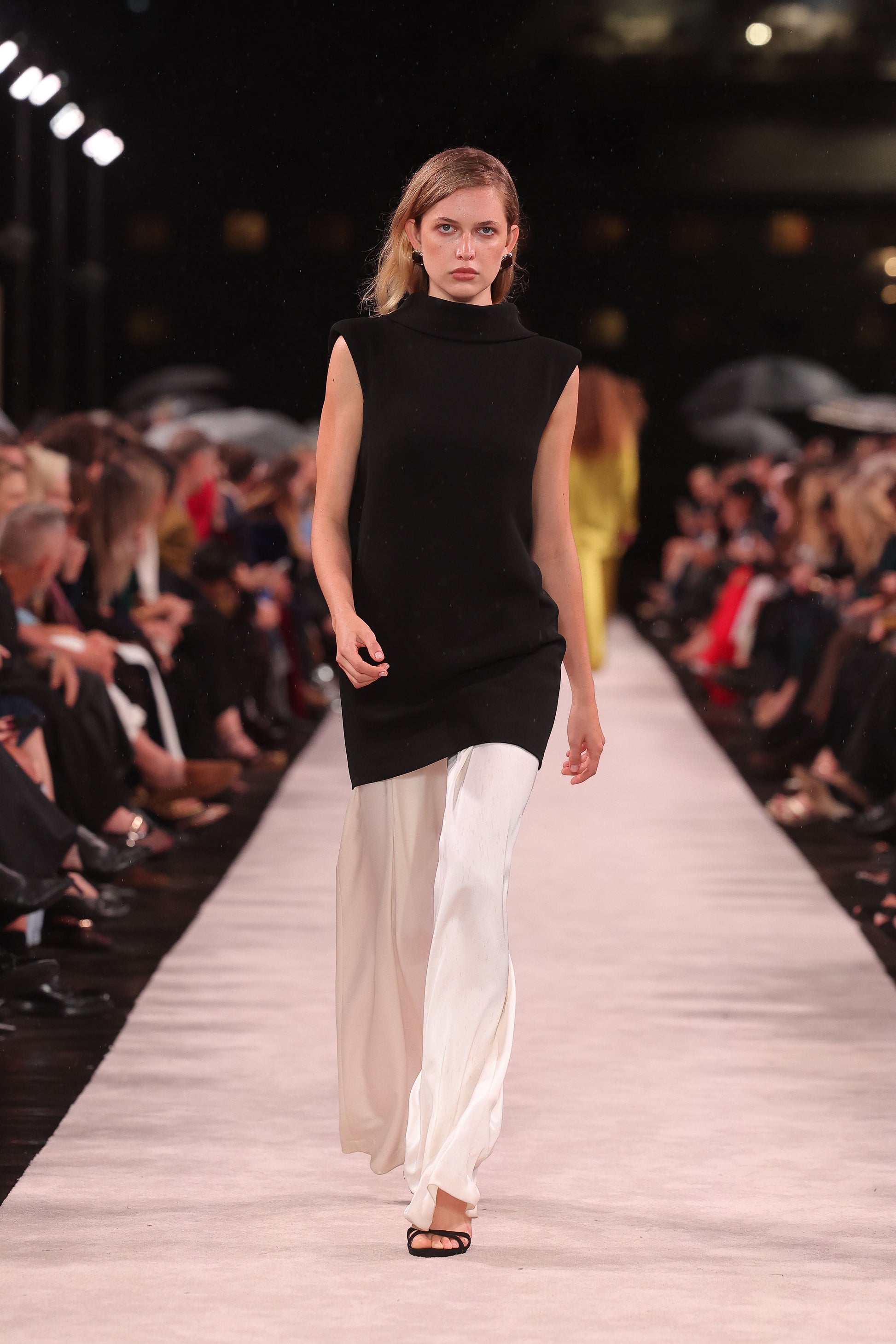 Image of a model wearing Pants. Product name - Ivory Satin Acetate Deep Pleat Pant in Ivory colour by brand - Carla Zampatti