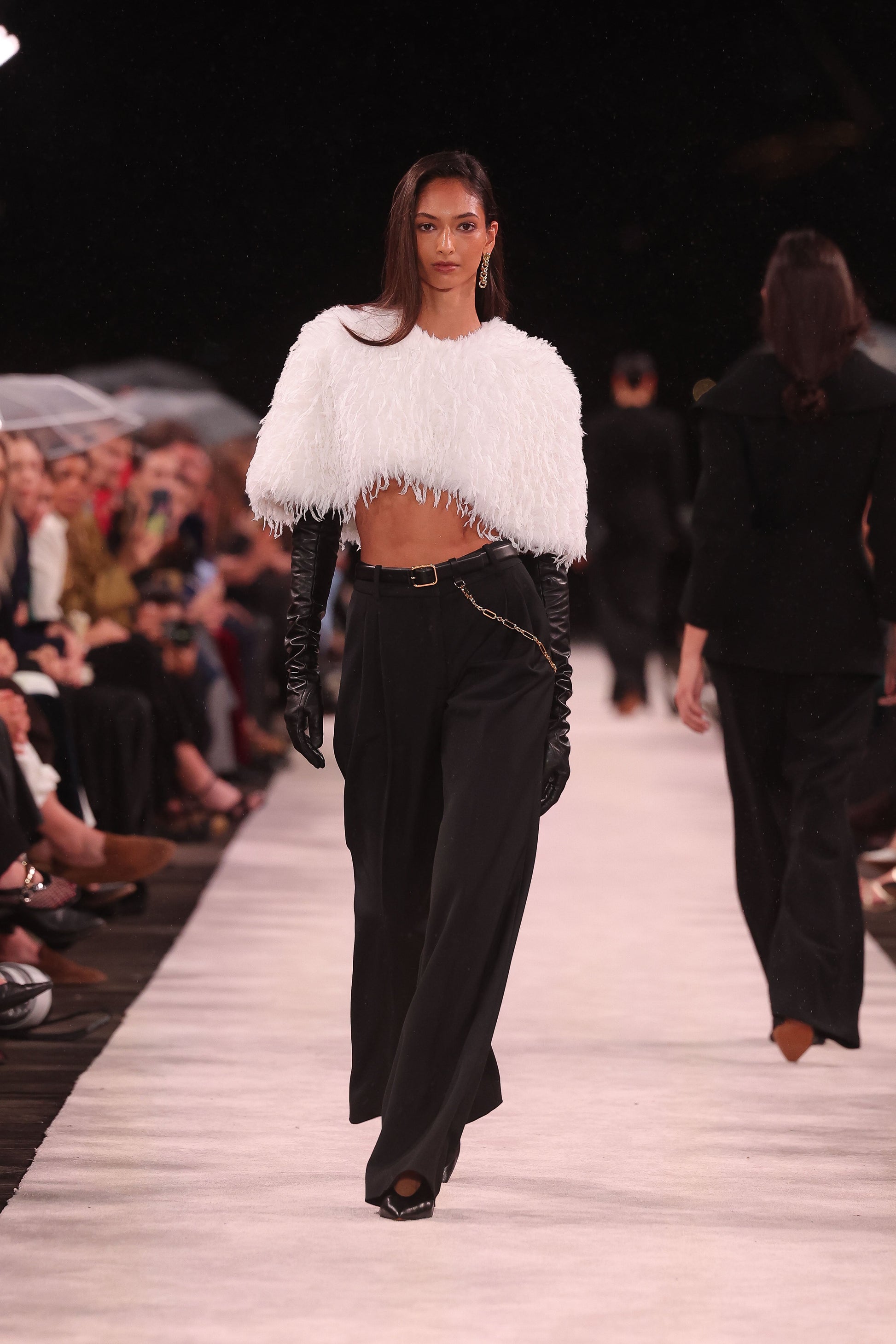 Image of a model wearing Shorts. Product name - Ivory Faux Plume Short Cape in Ivory colour by brand - Carla Zampatti