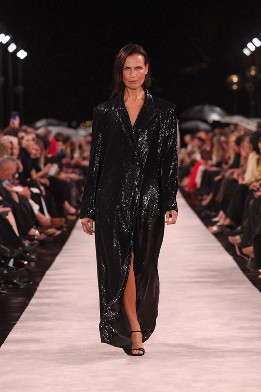 Image of a model wearing Outerwear. Product name - Black Liquid Sequin Double Breasted Coat in Black colour by brand - Carla Zampatti