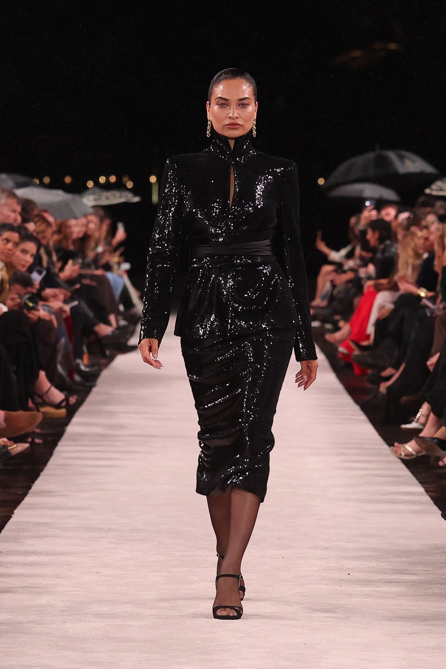 Image of a model wearing Skirts. Product name - Black Liquid Sequin Long Line Pencil Skirt in Black colour by brand - Carla Zampatti