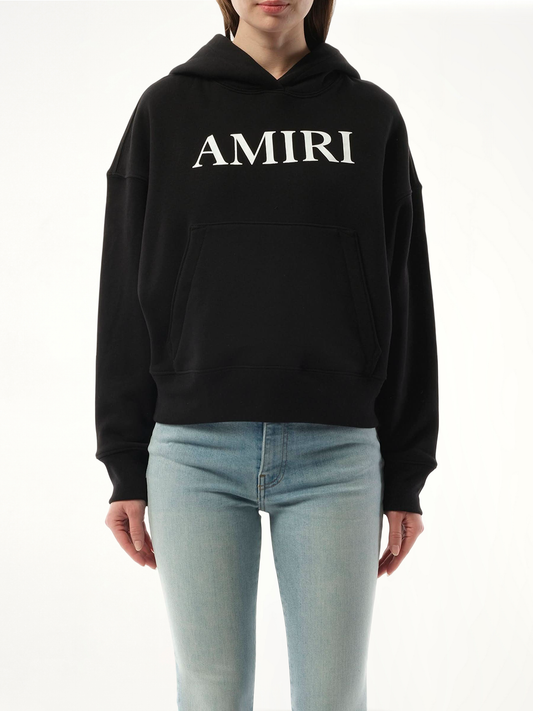 Image of a model wearing Outerwear. Product name - Amiri Core Logo Hoodie in Black colour by brand - AMIRI