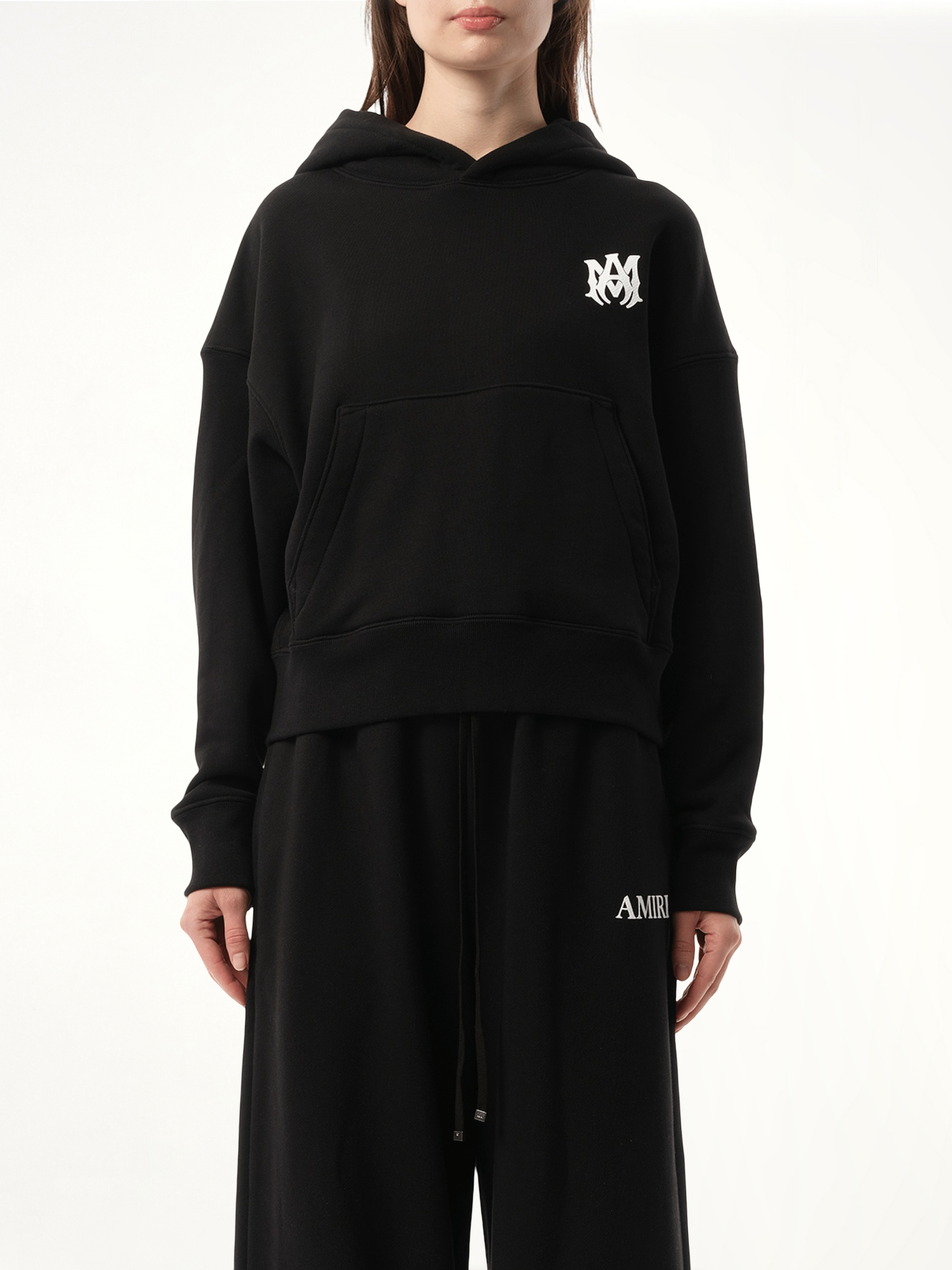 Image of a model wearing Outerwear. Product name - MA Core Logo Hoodie in Black colour by brand - AMIRI