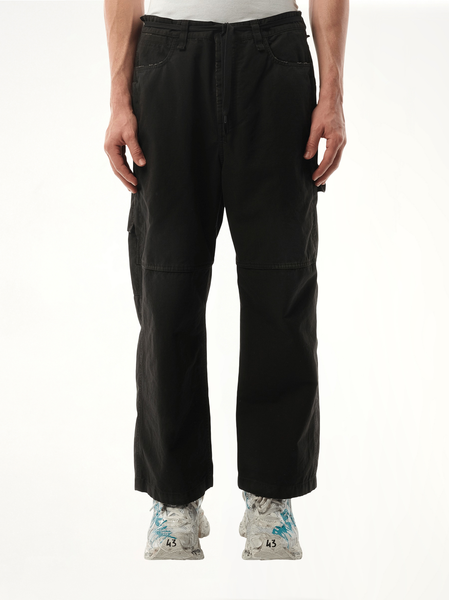 Image of a model wearing Pants. Productname: BALENCIAGA Cropped Skater Pants in Black colour by brand - BALENCIAGA