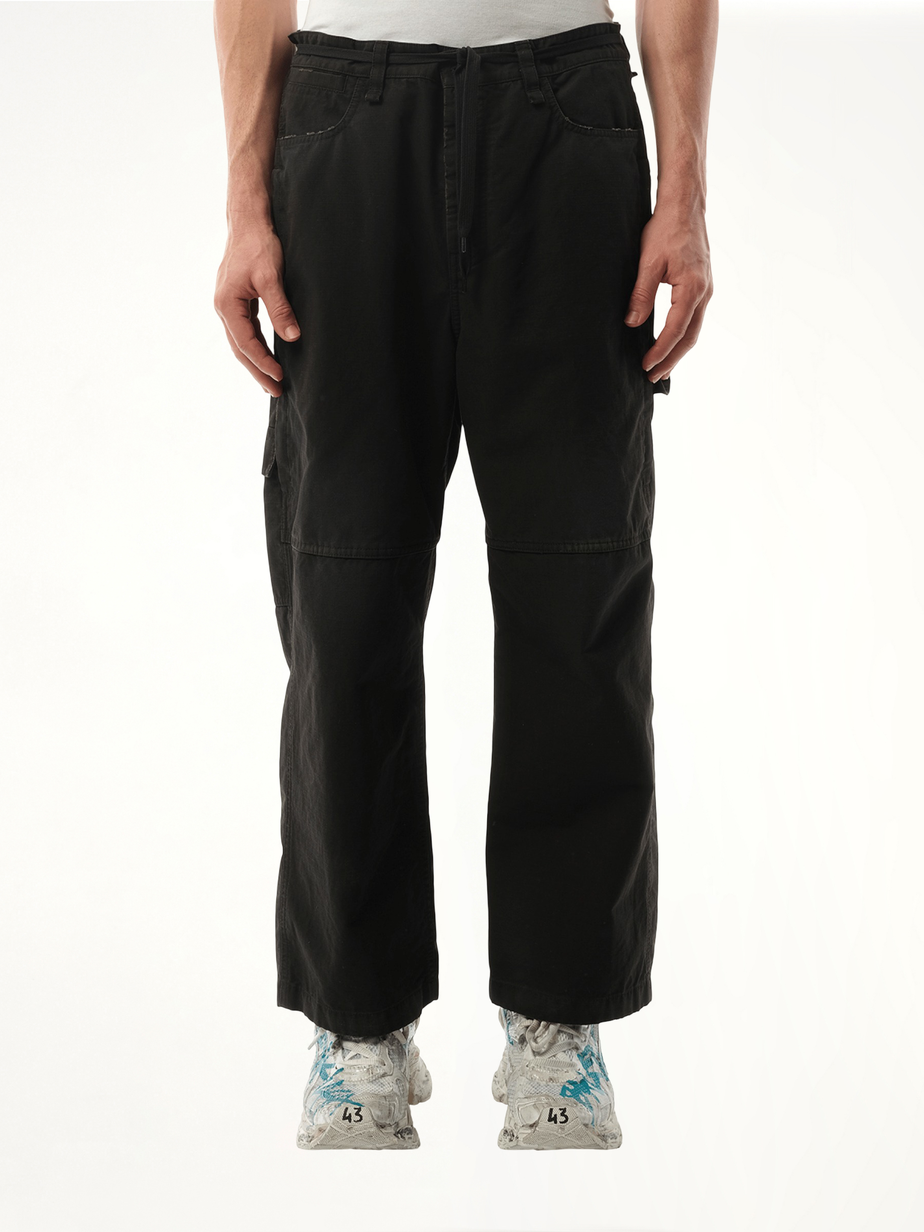 Image of a model wearing Pants. Productname: BALENCIAGA Cropped Skater Pants in Black colour by brand - BALENCIAGA