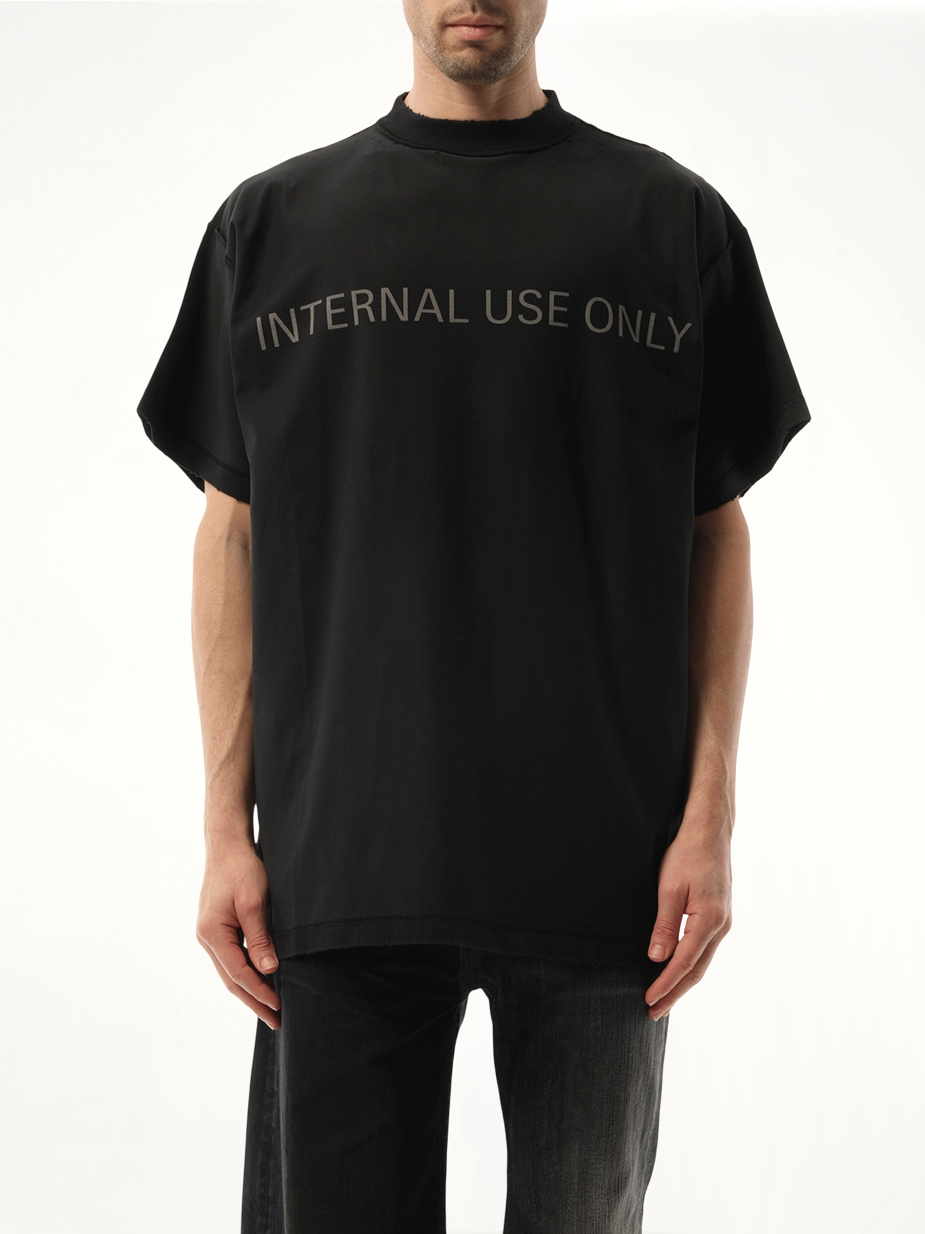 Image of a model wearing Tops. Productname: BALENCIAGA Internal Use Only Inside Out Oversized T-Shirt in BLACK colour by brand - BALENCIAGA