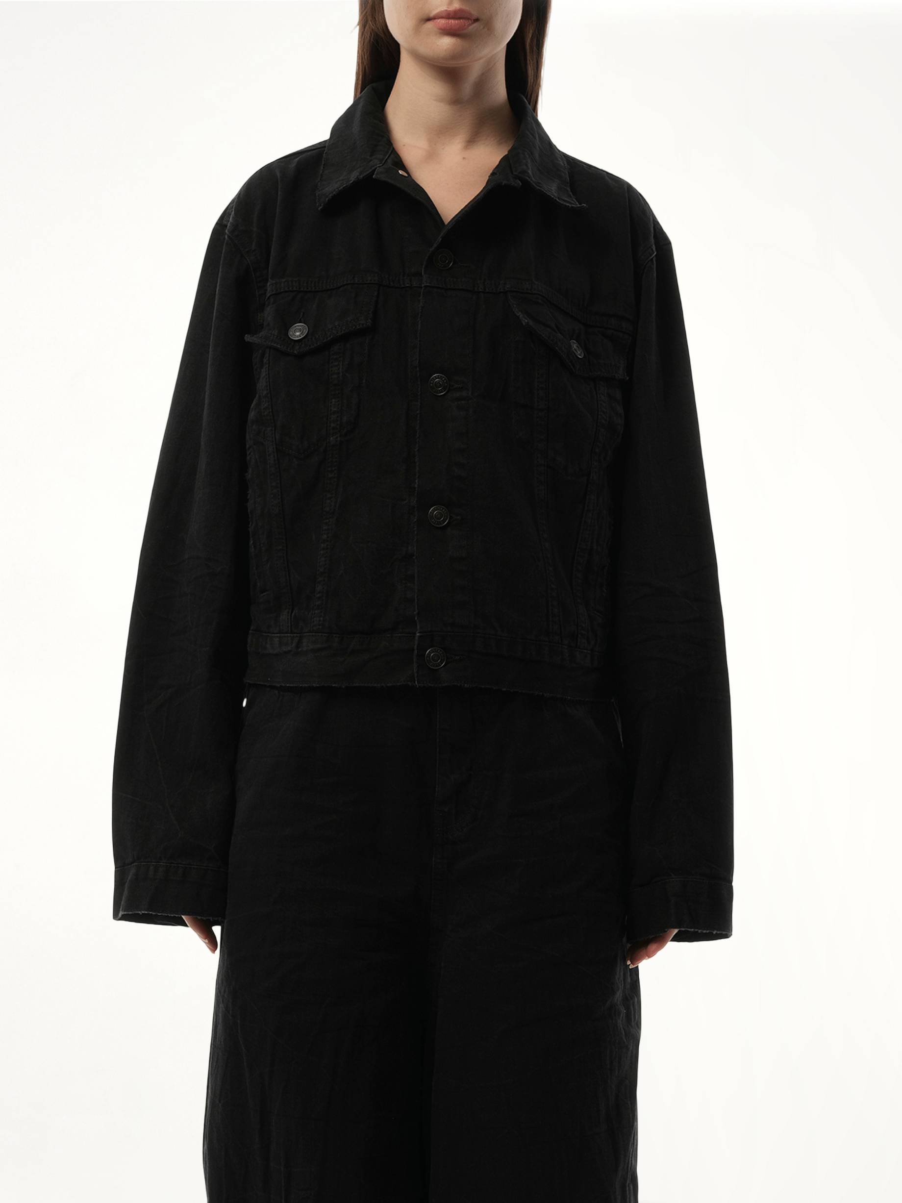 Image of a model wearing Outerwear. Productname: BALENCIAGA Small Fit Logo Denim Jacket in Black colour by brand - BALENCIAGA