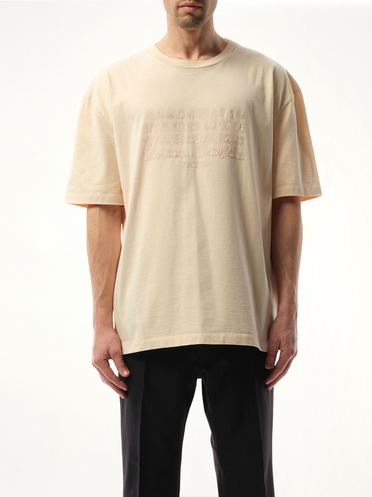 Image of a model wearing Tops. Productname: MAISON MARGIELA Memory of Logo Heavy T-Shirt in Beige colour by brand - MAISON MARGIELA