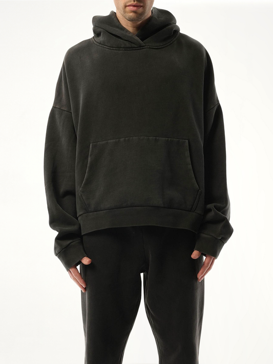 Image of a model wearing Outerwear. Product name - Heavy Hood in Black colour by brand - ENTIRE STUDIOS