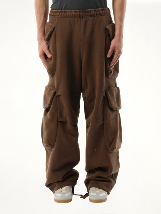 Image of a model wearing Pants. Productname: ENTIRE STUDIOS Heavy Gocar Sweatpants in BROWN colour by brand - ENTIRE STUDIOS