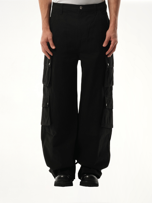 Image of a model wearing Pants. Productname: RHUDE Desert Cargos in BLACK colour by brand - RHUDE