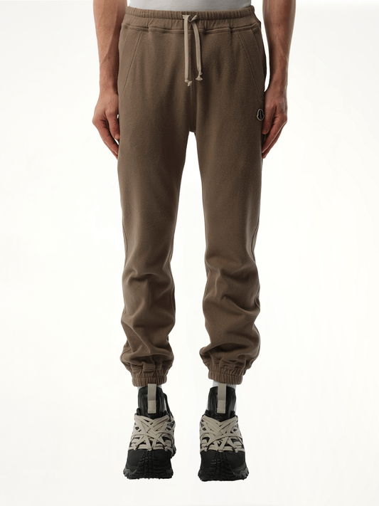 Image of a model wearing Pants. Productname: Rick Owens x Moncler Joggers in Brown colour by brand - RICK OWENS