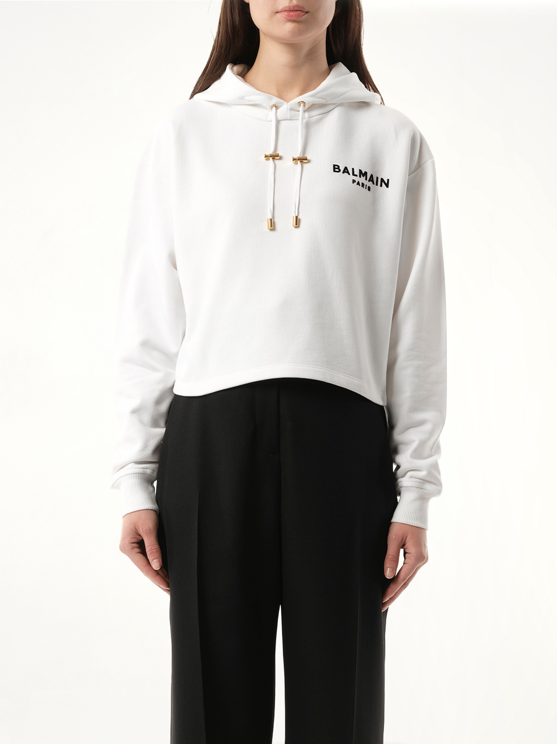 Image of a model wearing Outerwear. Productname: BALMAIN Balmain Flock Detail Cropped Hoodie in WHITE colour by brand - BALMAIN