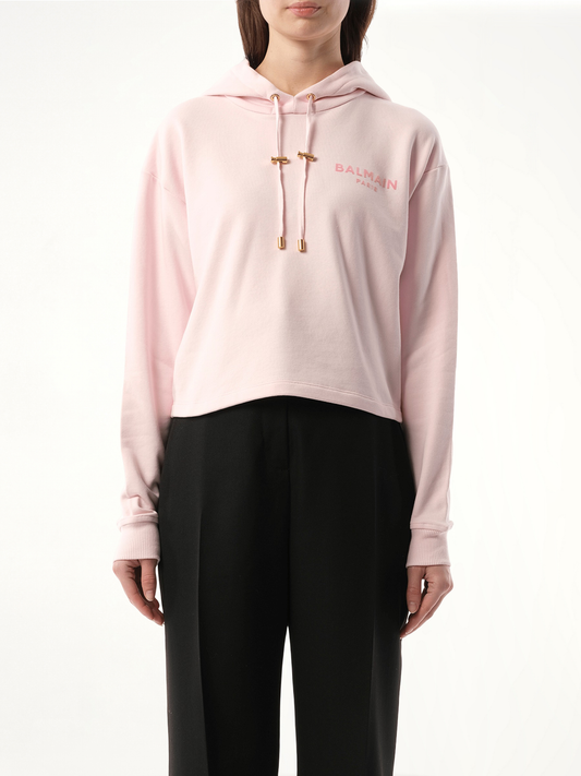 Image of a model wearing Outerwear. Productname: BALMAIN Balmain Flock Detail Cropped Hoodie in PINK colour by brand - BALMAIN
