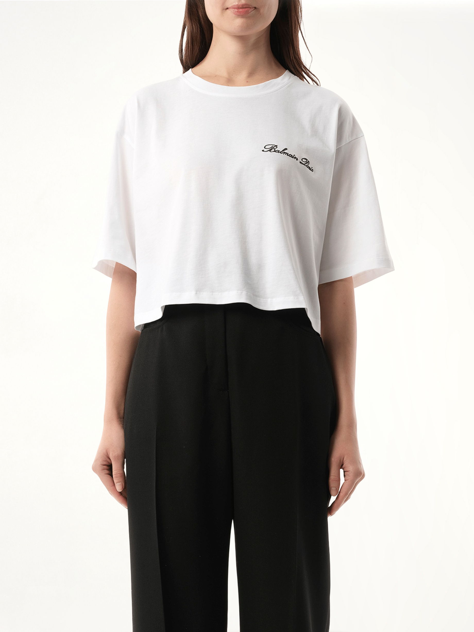 Image of a model wearing Tops. Productname: BALMAIN Balmain Signatured Embroidered Crop Top in WHITE colour by brand - BALMAIN
