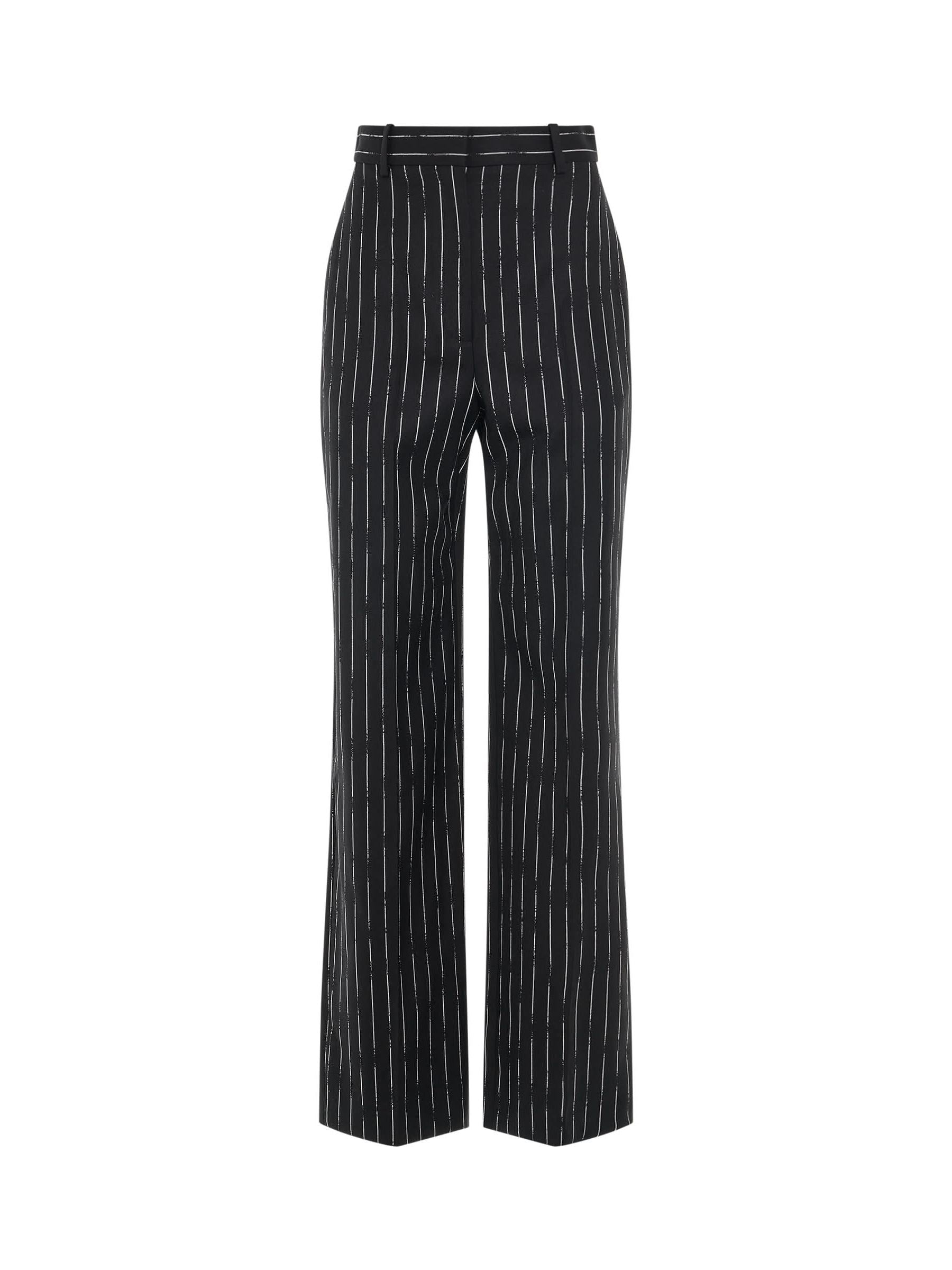 Image of a model wearing Pants. Productname: ALEXANDER MCQUEEN Certified Broken Stripe Wool Pants in Black colour by brand - ALEXANDER MCQUEEN