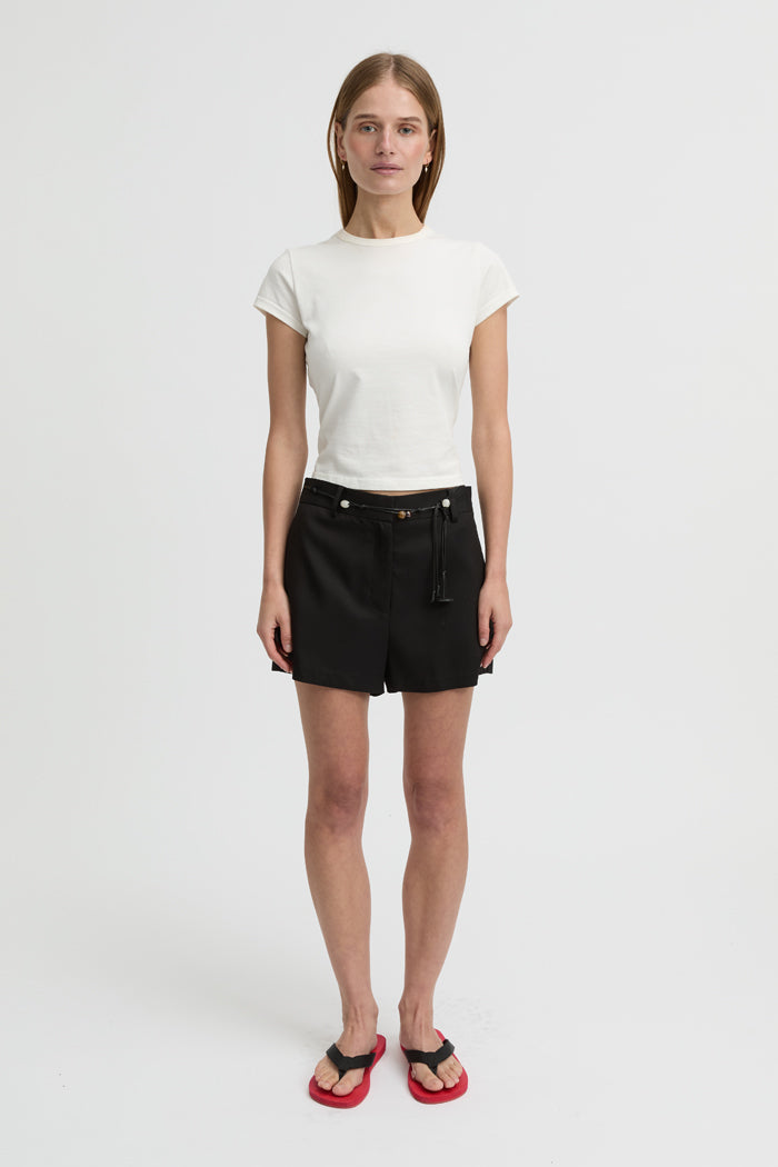 Image of a model wearing Shorts. Product name - Bean Shorts Black in Black colour by brand - Blanca Studio