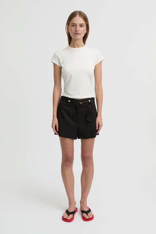 Image of a model wearing Shorts. Product name - Bean Shorts Black in Black colour by brand - Blanca Studio