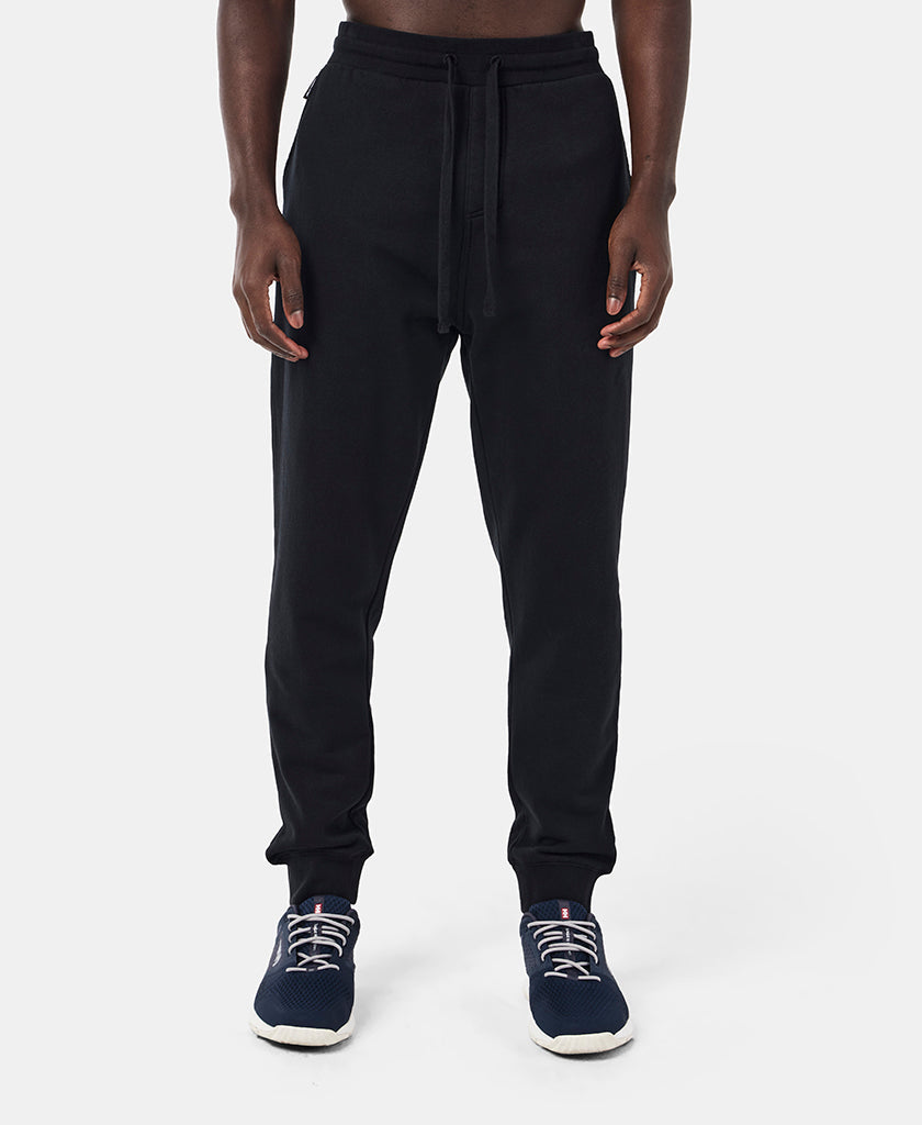 Image of a model wearing Pants. Product name - HH FLEECE PANT, Black in Black colour by brand - Helly Hansen